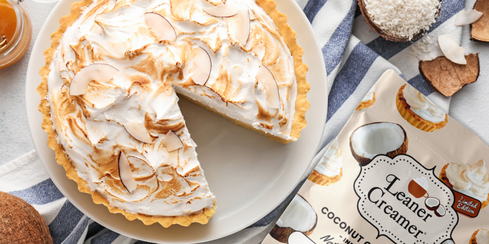 Coconut cream pie with toasted meringue and coconut flakes, next to Leaner Creamer’s coconut cream-flavored coffee creamer.